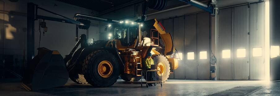 Kvinnlig servicetekniker utför service på Volvo L220H hjullastare